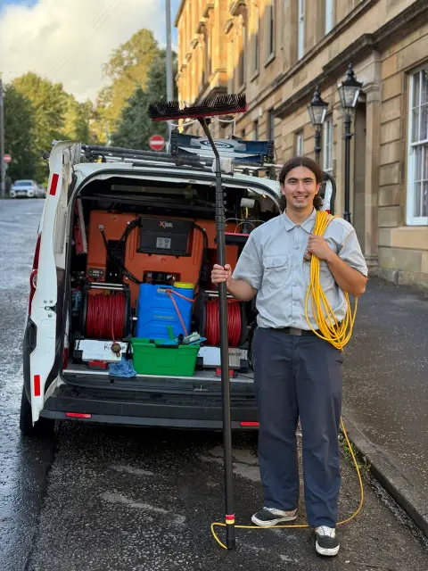 New Wave Cleaning technician with water-fed pole equipment
