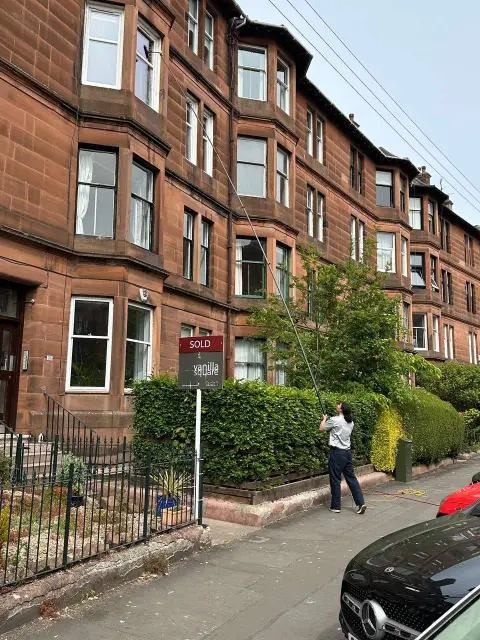 Exterior window cleaning of a red sandstone tenement in Glasgow